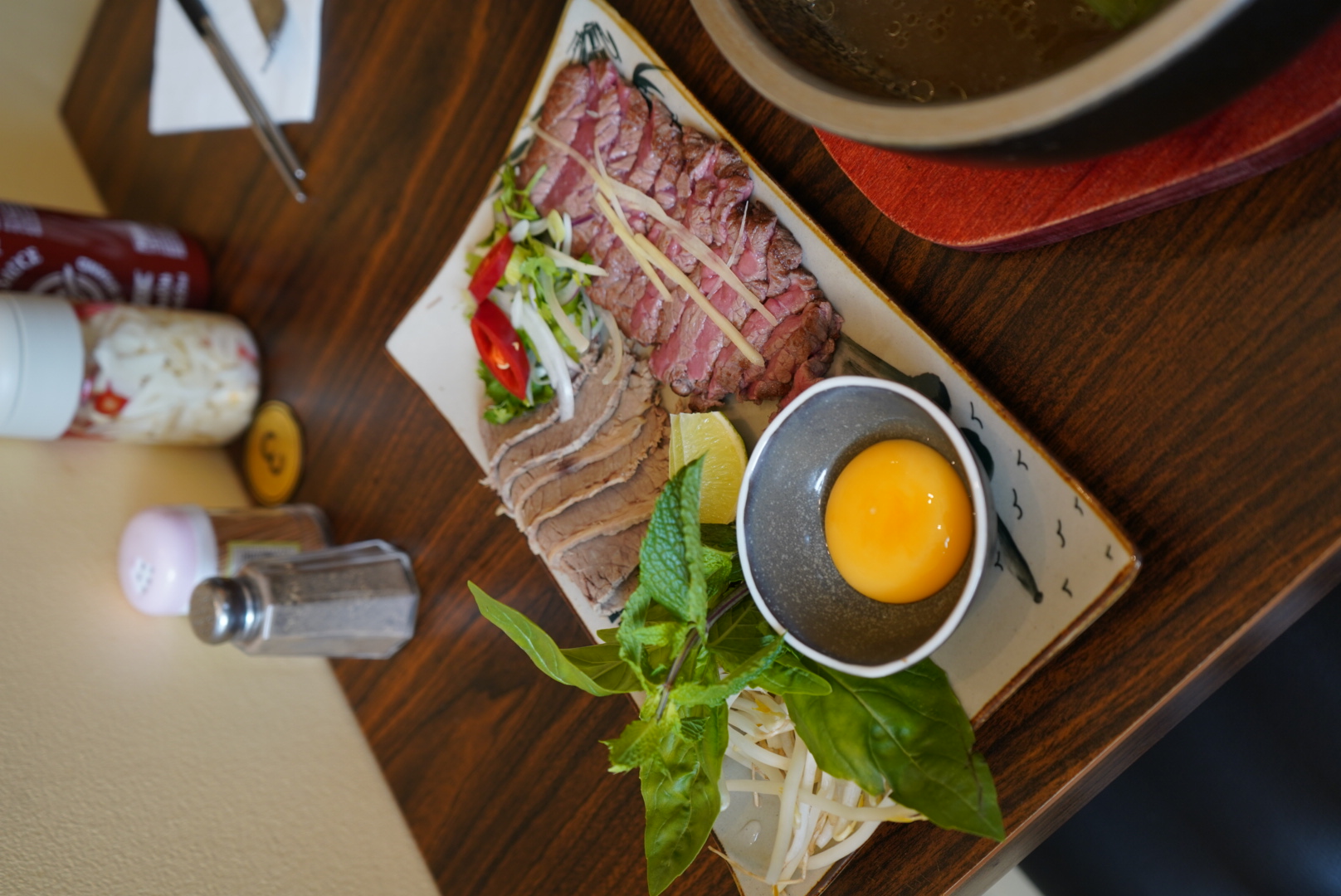 Fresh ingredients prepared for signature hot-stone phở